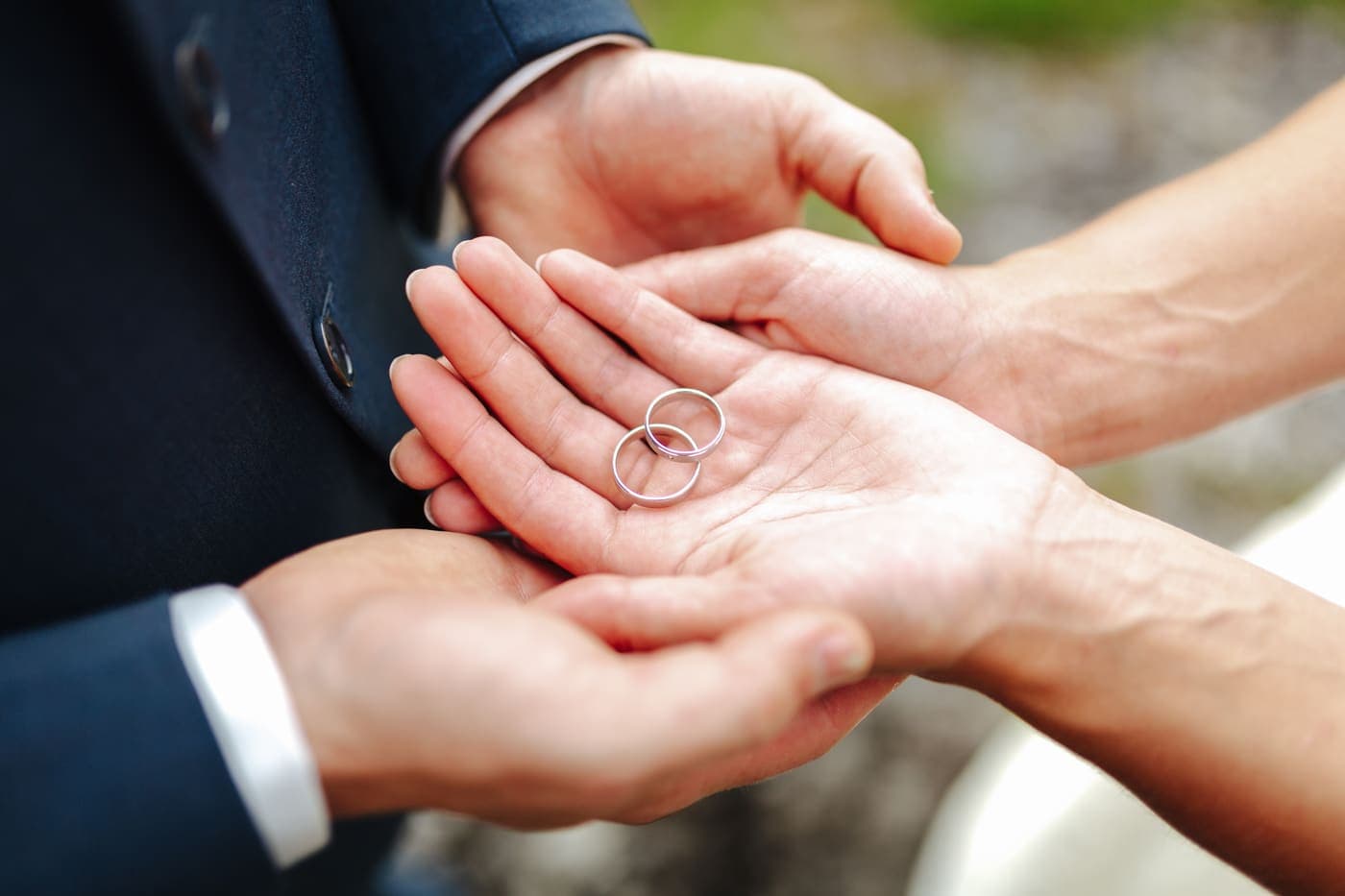 Two wedding rings resting in an open palm